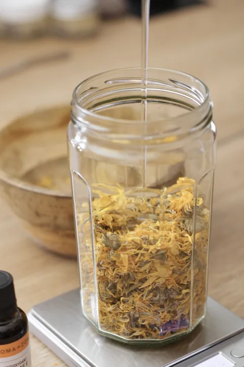 Huile versée sur des fleurs de calendula