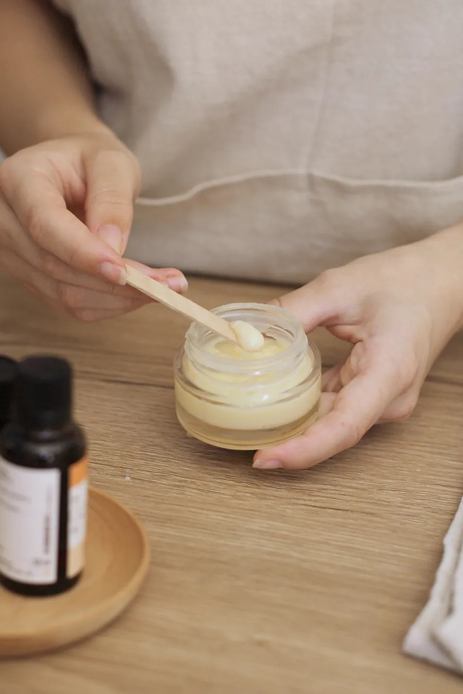 Une spatule mélange un baume dans son pot